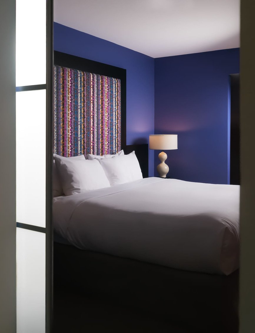 Angled view into a Superior King room at Opus Hotel